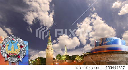 Moscow Kremlin (with decorations for the holiday of May 9 in honor of Victory Day celebration (WWII). Against the sky with clouds, Russia. TRANSLATION: USSR, Victory! 133494827