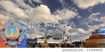 Moscow Kremlin (with decorations for the holiday of May 9 in honor of Victory Day celebration (WWII). Against the sky with clouds, Russia. TRANSLATION: USSR, Victory! 133494843