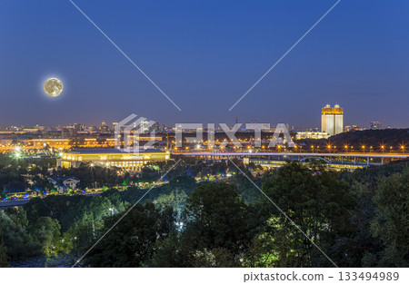 view of central Moscow from Sparrow Hills or Vorobyovy Gory observation platform, at night with the super moon-- is on a steep bank 85 m above the Moskva river, or 200 m above sea level. Russia view of central Moscow from Sparrow Hills or Vorobyovy Gory observation platform, at night with the super moon-- is on a steep bank 85 m above the Moskva river, or 200 m above sea level. Russia 133494989