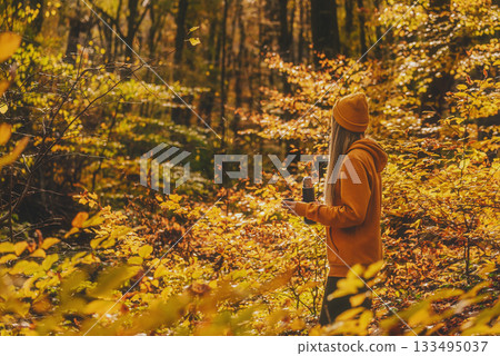 Young Woman Enjoying Solitude in Autumn Forest 133495037