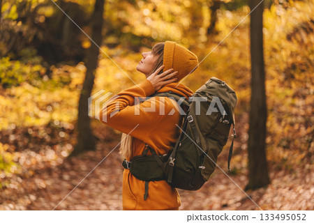 Happy Young Woman Hiking in Autumn Forest Happy Young Woman Hiking in Autumn Forest 133495052