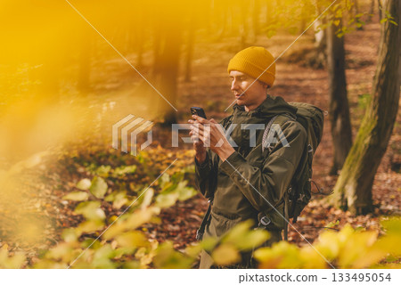 Man Hiker Using Smartphone for Navigation in Forest Man Hiker Using Smartphone for Navigation in Forest 133495054