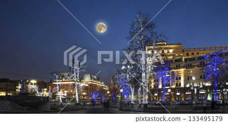 Trees illuminated to Christmas and New Year holidays at night (with the super moon) in Moscow, Russia Trees illuminated to Christmas and New Year holidays at night (with the super moon) in Moscow, Russia 133495179