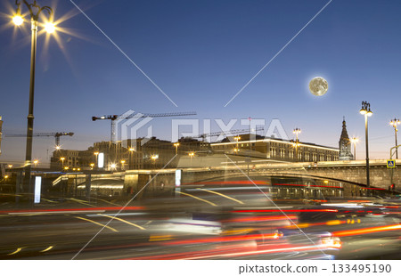 Night traffic on the Moskvoretskaya Embankment near the park Zaryadye (with the super moon), Moscow, Russia 133495190