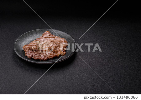 Grilled beef steak, meat cooked on barbecue with salt and pepper. Grilled beef steak Grilled beef steak, meat cooked on barbecue with salt and pepper. Grilled beef steak 133496060