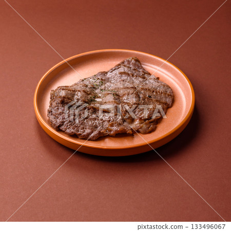 Grilled beef steak, meat cooked on barbecue with salt and pepper. Grilled beef steak Grilled beef steak, meat cooked on barbecue with salt and pepper. Grilled beef steak 133496067