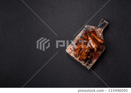 Grilled beef or pork ribs, meat cooked on a barbecue with salt and pepper. Grilled ribs Grilled beef or pork ribs, meat cooked on a barbecue with salt and pepper. Grilled ribs 133496095