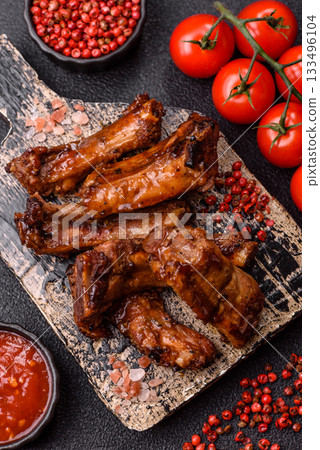 Grilled beef or pork ribs, meat cooked on a barbecue with salt and pepper. Grilled ribs Grilled beef or pork ribs, meat cooked on a barbecue with salt and pepper. Grilled ribs 133496104