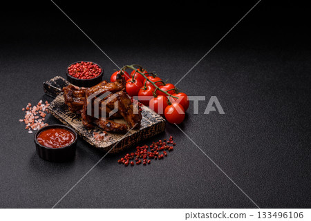 Grilled beef or pork ribs, meat cooked on a barbecue with salt and pepper. Grilled ribs Grilled beef or pork ribs, meat cooked on a barbecue with salt and pepper. Grilled ribs 133496106