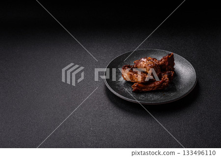 Grilled beef or pork ribs, meat cooked on a barbecue with salt and pepper. Grilled ribs Grilled beef or pork ribs, meat cooked on a barbecue with salt and pepper. Grilled ribs 133496110