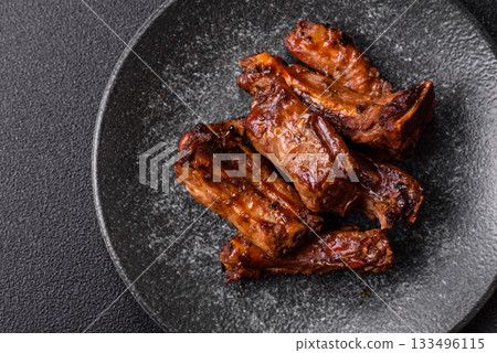 Grilled beef or pork ribs, meat cooked on a barbecue with salt and pepper. Grilled ribs 133496115