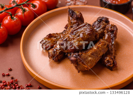 Grilled beef or pork ribs, meat cooked on a barbecue with salt and pepper. Grilled ribs Grilled beef or pork ribs, meat cooked on a barbecue with salt and pepper. Grilled ribs 133496128