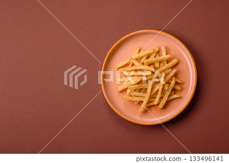 Crispy French fries with sauce, fast food, snack or chips. French fries, takeaway food 133496141