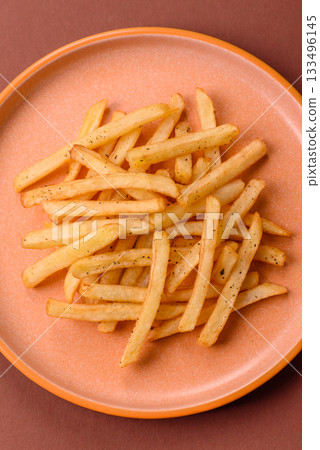 Crispy French fries with sauce, fast food, snack or chips. French fries, takeaway food 133496145