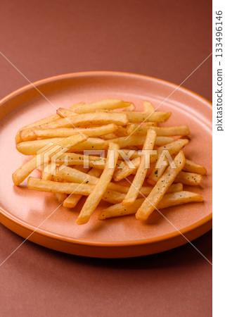 Crispy French fries with sauce, fast food, snack or chips. French fries, takeaway food Crispy French fries with sauce, fast food, snack or chips. French fries, takeaway food 133496146