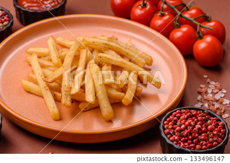 Crispy French fries with sauce, fast food, snack or chips. French fries, takeaway food Crispy French fries with sauce, fast food, snack or chips. French fries, takeaway food 133496147