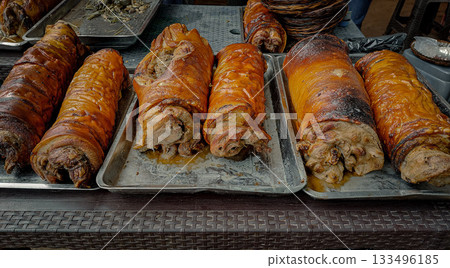 Assortment of roasted pork belly roll called bellychon displayed at a food market, authentic local Filipino food Assortment of roasted pork belly roll called bellychon displayed at a food market, authentic local Filipino food 133496185