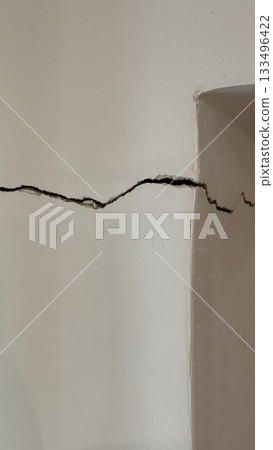 Crack on wall with texture, suitable as background or concept for damage and repair themes 133496422