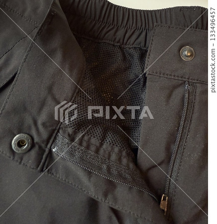 Black jacket with visible zipper and mesh lining, showcasing details and texture 133496457