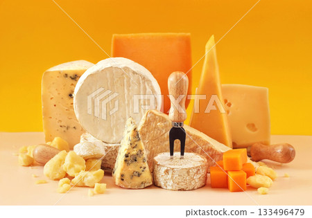 Colorful mix of cheese varieties: brie and camembert, blue gorgonzola and parmesan, gauda and cheddar. Food ingredients background 133496479