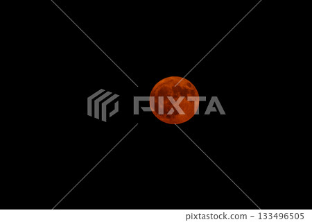 Full Moon with Orange Hue Against a Black Sky 133496505