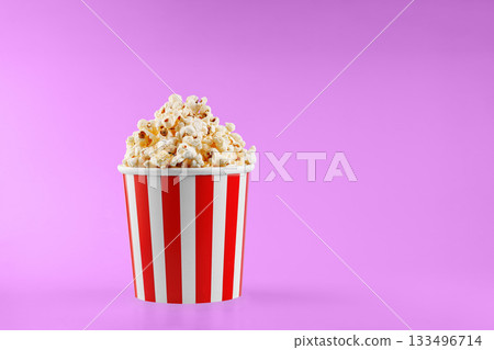 Classic red striped popcorn cardboard cup on Pink background 133496714