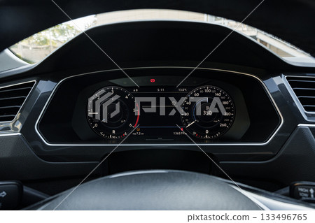 Dashboard display showing vehicle speed and fuel level in a modern car interior 133496765