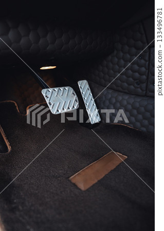 Close view of car pedals showing modern design and sleek materials in a stylish interior Close view of car pedals showing modern design and sleek materials in a stylish interior 133496781
