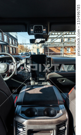 Luxury SUV interior shows modern design and technology in urban setting 133496785
