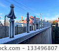 Frost-covered fence of a house on a sunny frosty winter day 133496807