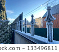 House fence covered with frost on a sunny winter day 133496811