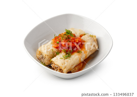 Savory stuffed cabbage rolls with tomato sauce served in a white bowl Savory stuffed cabbage rolls with tomato sauce served in a white bowl 133496837