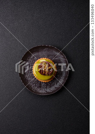 Pistachio cake or tart topped with green mousse with nuts and fruit filling. Pistachio pie Pistachio cake or tart topped with green mousse with nuts and fruit filling. Pistachio pie 133496840