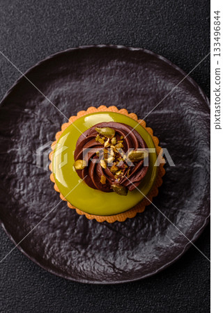 Pistachio cake or tart topped with green mousse with nuts and fruit filling. Pistachio pie Pistachio cake or tart topped with green mousse with nuts and fruit filling. Pistachio pie 133496844