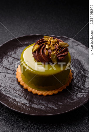 Pistachio cake or tart topped with green mousse with nuts and fruit filling. Pistachio pie Pistachio cake or tart topped with green mousse with nuts and fruit filling. Pistachio pie 133496845