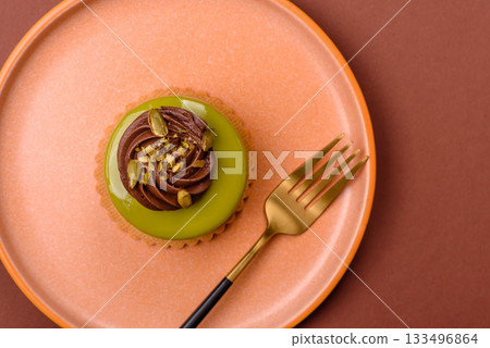 Pistachio cake or tart topped with green mousse with nuts and fruit filling. Pistachio pie Pistachio cake or tart topped with green mousse with nuts and fruit filling. Pistachio pie 133496864