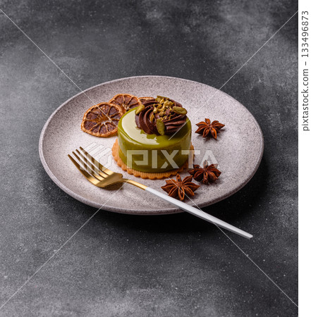 Pistachio cake or tart topped with green mousse with nuts and fruit filling. Pistachio pie Pistachio cake or tart topped with green mousse with nuts and fruit filling. Pistachio pie 133496873