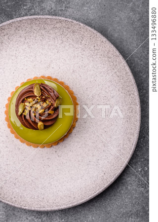 Pistachio cake or tart topped with green mousse with nuts and fruit filling. Pistachio pie Pistachio cake or tart topped with green mousse with nuts and fruit filling. Pistachio pie 133496880