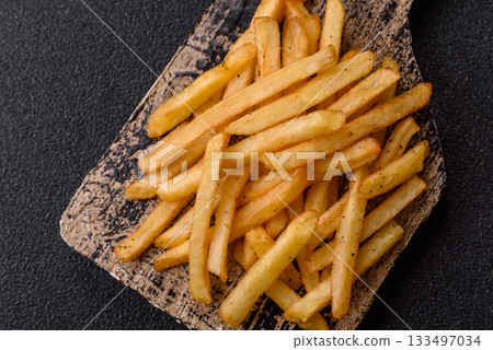 Crispy French fries with sauce, fast food, snack or chips. French fries, takeaway food 133497034