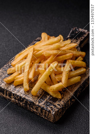 Crispy French fries with sauce, fast food, snack or chips. French fries, takeaway food 133497037