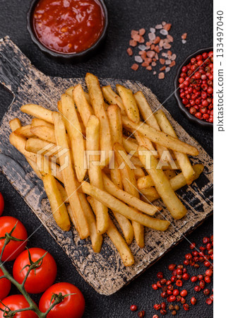 Crispy French fries with sauce, fast food, snack or chips. French fries, takeaway food 133497040