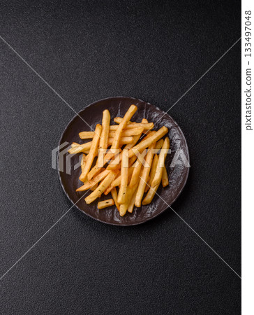 Crispy French fries with sauce, fast food, snack or chips. French fries, takeaway food Crispy French fries with sauce, fast food, snack or chips. French fries, takeaway food 133497048