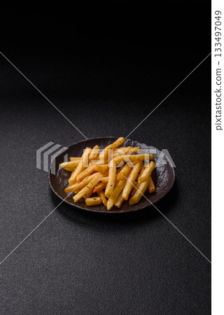 Crispy French fries with sauce, fast food, snack or chips. French fries, takeaway food Crispy French fries with sauce, fast food, snack or chips. French fries, takeaway food 133497049