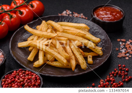 Crispy French fries with sauce, fast food, snack or chips. French fries, takeaway food Crispy French fries with sauce, fast food, snack or chips. French fries, takeaway food 133497054