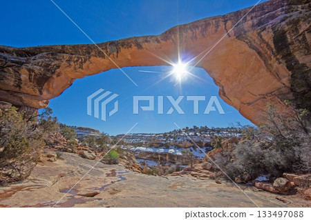 Sunburst through Natural Sandstone Arch in Utah Winter Sunburst through Natural Sandstone Arch in Utah Winter 133497088