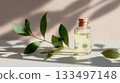 Natural essential oil with green leaves on a light background in calming sunlight 133497148