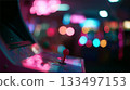 Neon lights glow on an arcade gaming machine in a vibrant entertainment space 133497153