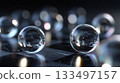 Glass marbles on a black and white checkerboard surface with blurred background details 133497157