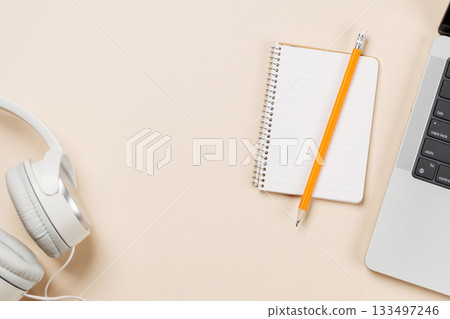 Laptop and stationery on beige workspace, top view with copy space 133497246