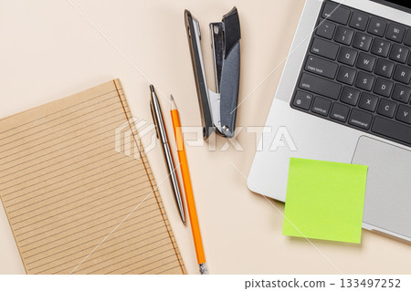 Blank notepad, laptop and stationery on beige workspace, top view with copy space Blank notepad, laptop and stationery on beige workspace, top view with copy space 133497252